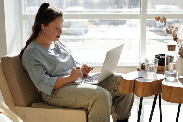 Supported Independent Living resident using laptop with SIL support